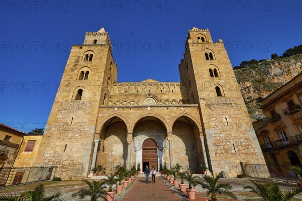 Impressive cathedral with main façade and symmetrical towers in clear skies, historic atmosphere, Cefalu, cathedral, UNESCO World Heritage Site, Sicily, Italy