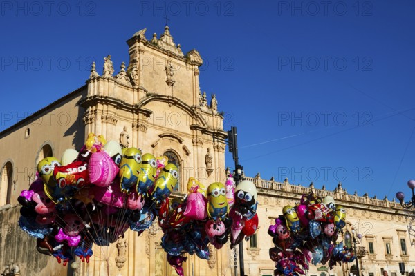 Scigli, Easter Sunday, glowing balloons floating in front of a church, standing out against the blue sky, Baroque towns of Sicily, Baroque corner of Sicily, late Baroque towns of Val di Noto, UNESCO World Heritage Site, Sicily, Italy