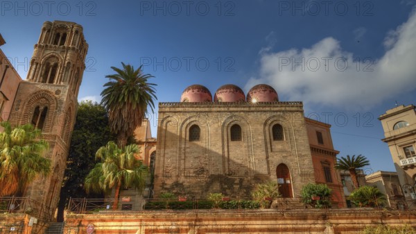 Side view of an Arab-Norman building with red domes and palm trees in sunny weather, Palermo, San Cataldo Church, UNESCO World Heritage Site, Sicily, Italy