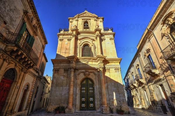 Scigli, magnificent baroque church under clear blue sky, typical of historical architecture, Baroque towns of Sicily, Baroque corner of Sicily, late Baroque towns of Val di Noto, UNESCO World Heritage Site, Sicily, Italy