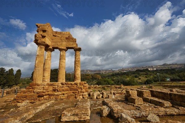 Temple of Dioscuren, temple ruins in sandstone landscape under dramatic sky, Valley of the Temples, Valle dei Templi, Archaeological Site, UNESCO World Heritage Site, Agrigento, Sicily, Italy
