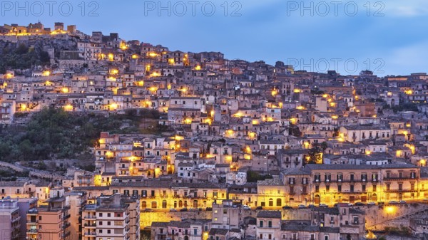 Modica, evening view of a mountainous urban landscape with illuminated houses, Baroque towns of Sicily, Baroque corner of Sicily, late Baroque towns of Val di Noto, UNESCO World Heritage Site, Sicily, Italy