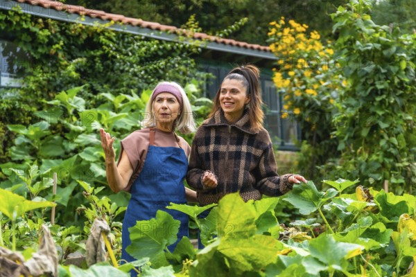 Mother and adult daughter enjoying time together in a lush green garden, the older woman teaching and sharing her gardening experience with the younger woman