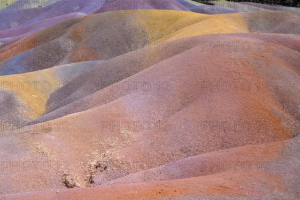 Rolling hills of colored sand form a unique landscape in rainbow colors. Africa, East Africa, Mauritius, Chamarel, Seven Coloured Earth