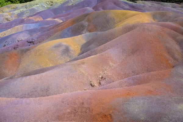 Bright multi-colored mounds of sand that form a wavy pattern. Africa, East Africa, Mauritius, Chamarel, Seven Coloured Earth