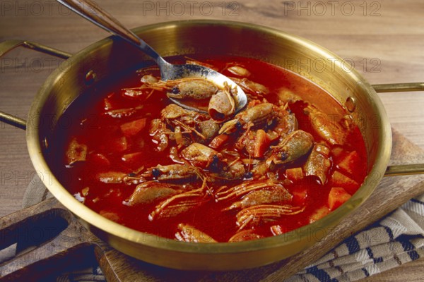 French shrimp bisque soup, in a pot, close-up, no people