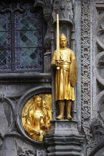 Golden figures on the façade of the St. Ivo Chapel at the Basilica of the Holy Blood, Castle Square in the historic old town, Bruges, UNESCO World Heritage Site, Flanders, Belgium