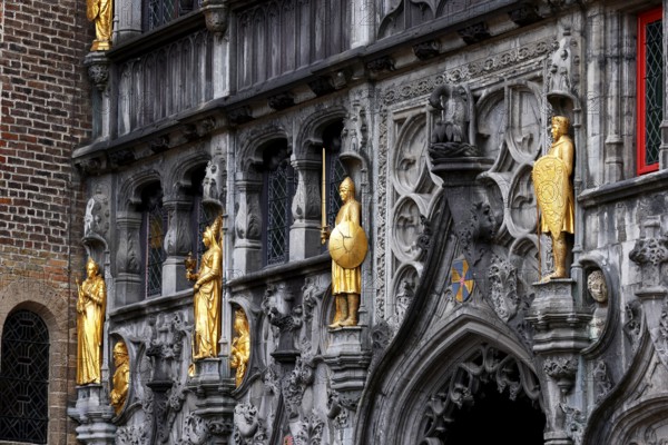 Richly decorated façade and entrance portal with golden figures to the St. Ivo Chapel at the Basilica of the Holy Blood, Castle Square in the historic old town, Bruges, UNESCO World Heritage Site, Flanders, Belgium