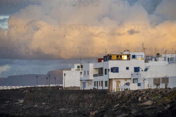 Typical white houses in the town of La Santa on the coast, at sunset, Lanzarote, Canary Islands, Spain