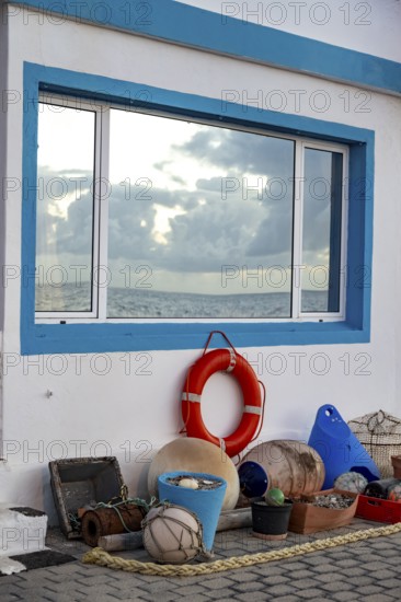 House façade decorated with fishing utensils, white house with blue windows, La Santa, Lanzarote, Canary Islands, Spain