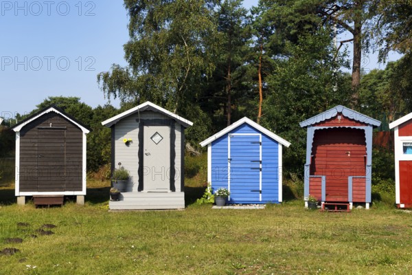 Different colored beach huts in a meadow, Ystad, Sweden