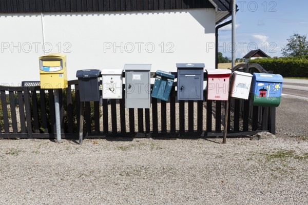 Many different mailboxes on a fence, Ystad, Sweden