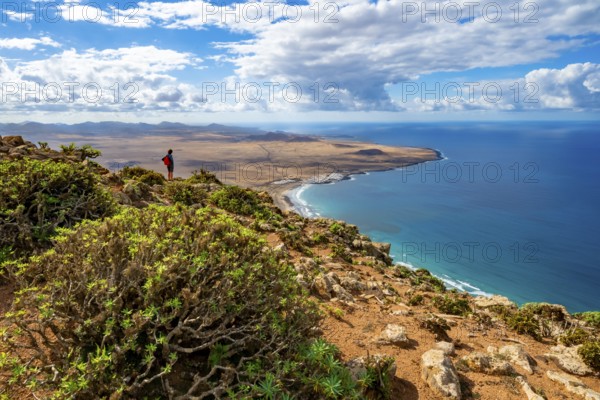 View from the Castillejo viewpoint from the Risco de Famara cliffs to the coast and the sea with the Famara beach, Playa de Famara, Lanzarote, Canary Islands, Spain
