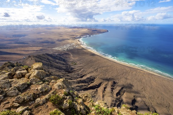 Castillejo viewpoint, view from the Risco de Famara cliffs to the coast and the sea with Famara beach, Playa de Famara with La Calaeta, Lanzarote, Canary Islands, Spain
