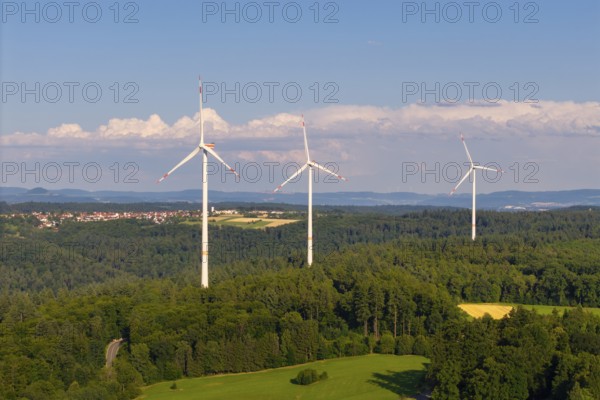 Three wind turbines on a hill in a rural landscape with forests and meadows, near Schorndorf, Rems-Murr-Kreis, Baden-Württemberg, Germany