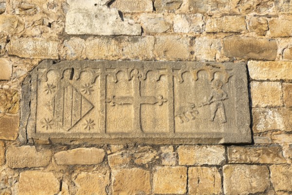 Religious stonework imagery on church wall, Echo or Hecho, Valle de Hecho, Pyrenees Mountains, Huesca province, Aragon, Spain