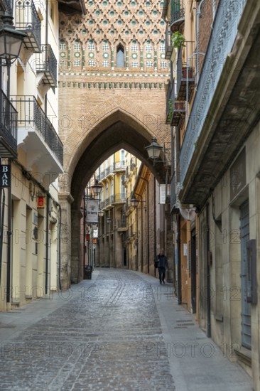 Archway street Mudéjar architecture of Torre de El Salvador church tower, city of Teruel, Aragon, Spain