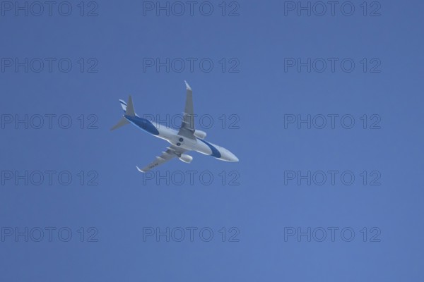 Boeing 737 jet passenger aircraft of El Al Israel airlines flying in a blue sky, England, United Kingdom