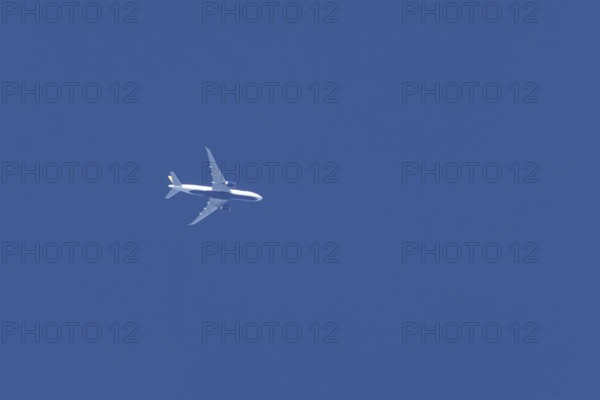 Boeing jet passenger aircraft flying in a blue sky, England, United Kingdom