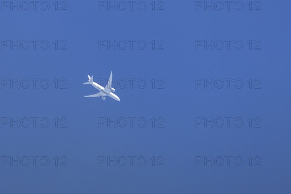 Boeing 787-8 Dreamliner jet passenger aircraft of Qatar airways airlines flying in a blue sky, England, United Kingdom