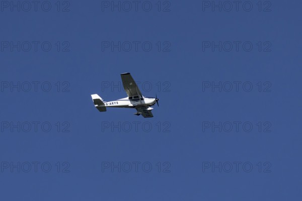 Cessna 172C Skyhawk aircraft flying in a blue sky, England, United Kingdom