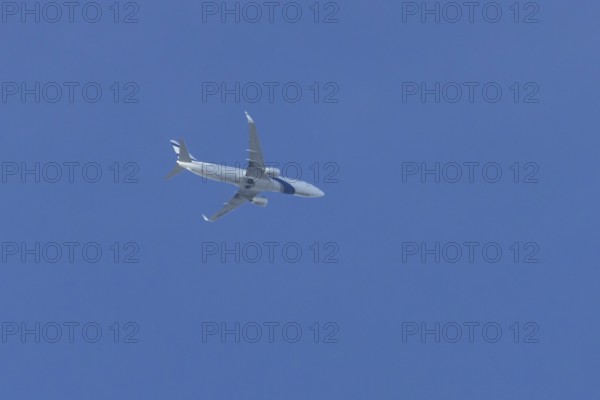 Boeing 737 jet passenger aircraft of El Al Israel airlines flying in a blue sky, England, United Kingdom
