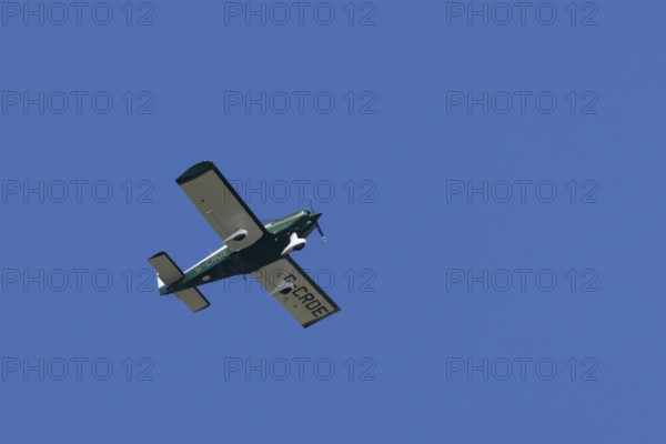 Robin HR200-120B light aircraft flying in a blue sky, England, United Kingdom
