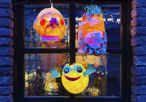 Homemade lanterns for the Martin procession in front of a window in the evening, Old Town, Kempen, Lower Rhine, North Rhine-Westphalia, Germany