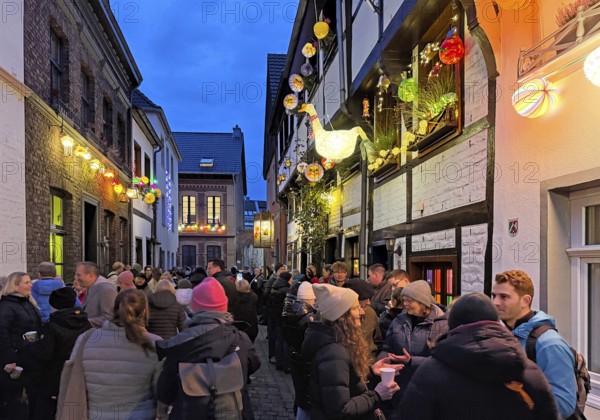People on the Alte Schulstraße decorated for the Martin train in the evening, Old Town, Kempen, Lower Rhine, North Rhine-Westphalia, Germany