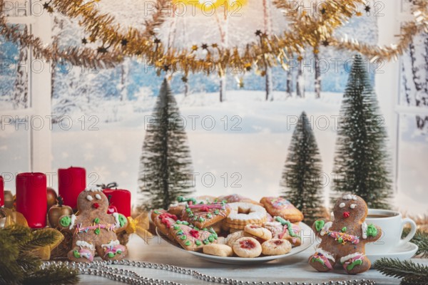 Christmas table with cookies and decorations in front of snow-white landscape