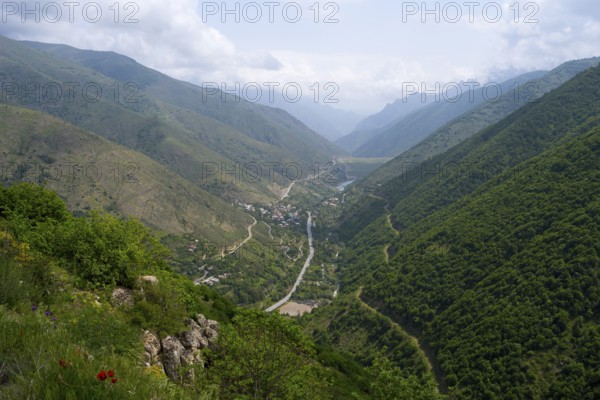 Extensive mountain landscape with a river surrounded by lush vegetation and clouds in the sky, view of Lernadzor, surrounded by the mountains of the Zangesur Range, Zangesur, Syunik Province, Caucasus, Armenia