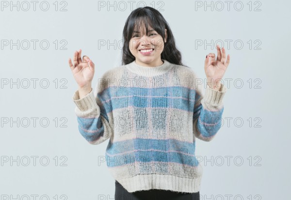 Smiling female interpreter gesturing OK in sign language. Smiling asian girl gesturing okay in language nonverbal