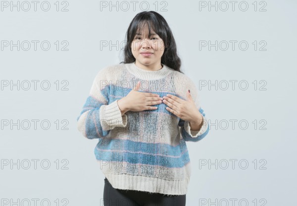 Asian girl gesturing GRATITUDE in sign language. Young woman making gesture GRATEFUL in sign language isolated