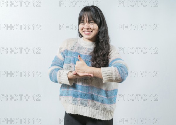 Asian girl gesturing help with hands in nonverbal language. Smiling woman showing help gesture with hands in sign language
