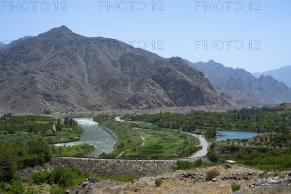 A river snakes through a lush landscape with mountains, views of Iran, Aras River near Meghri, Syunik Province, Syunik, Armenia