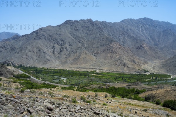 A vast valley with green vegetation surrounded by dry mountains, views of Iran, Aras River near Meghri, Syunik Province, Syunik, Armenia