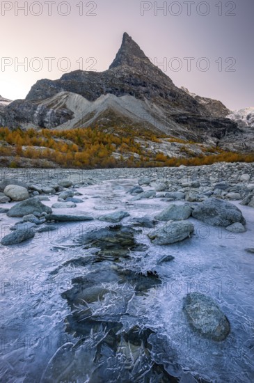 Ice structures on mountain stream with autumnal larches and mountain views, Mont Mine, Ferpecle glacier, Val d'Herens, Canton of Valais, Switzerland