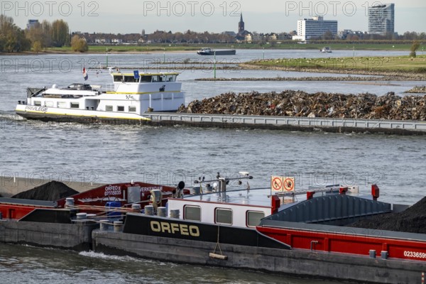 Dutch cargo ship Orfeo, brings power plant coal from the Netherlands to Mannheim, here on the Rhine near Düsseldorf, behind freighter with scrap metal, sails downhill, North Rhine-Westphalia, Germany