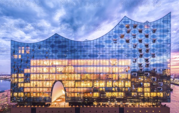 Aerial view of the Elbe Philharmonic Hall with reflections on the façade in the evening light above the harbor, Hamburg, Germany