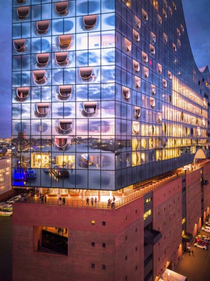 Aerial view of the Elbe Philharmonic Hall with reflections on the façade in the evening light above the harbor, Hamburg, Germany