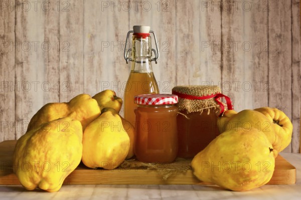 Still life with quinces, homemade quince jelly and quince liqueur, autumn, Germany