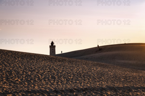 Rubjerg Knude lighthouse, walkers on hiking dune, evening mood in summer, Løkken, Lokken, Nordjylland, North Jutland, Denmark