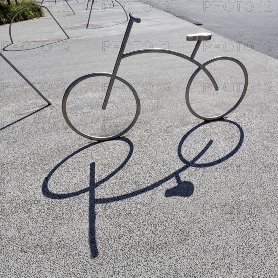 Bicycle, stainless steel bicycle rack, casts shade, bicycle parking, Aalborg, Jutland, Denmark