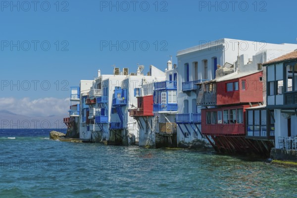 Mykonos, Cyclades, Greece - Little Venice is a picturesque neighborhood in Mykonos Town with colorful houses that stand right by the sea and are reminiscent of Venice. Little Venice is located on Alefkandra Bay next to the famous windmills of Mykonos. Mykonos is part of the Cyclades archipelago in the Aegean Sea