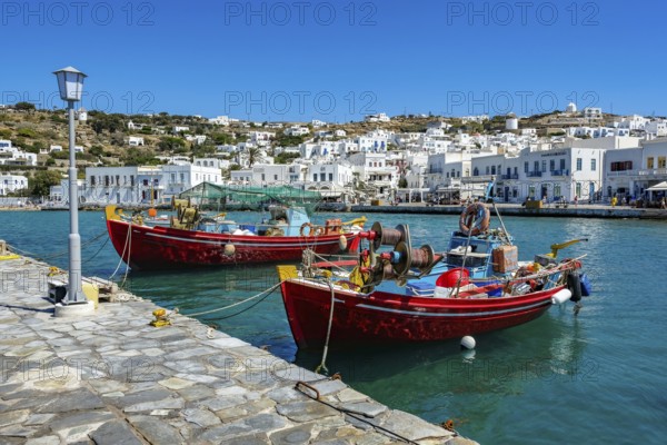 Mykonos, Cyclades, Greece - Colourful fishing boats are moored on the quay in the old port of Mykonos Town, Mykonos Chora. Mykonos is part of the Cyclades archipelago