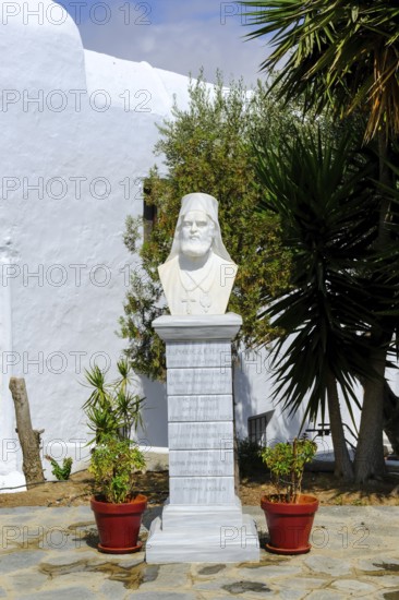 Ano Mera, Mykonos, Cyclades, Greece - The Panagia Tourliana monastery is the center of Ano Mera. Bust in the garden. The men's convent from the 16th century on the village square in the interior of the island is now a tourist attraction much visited by tourists