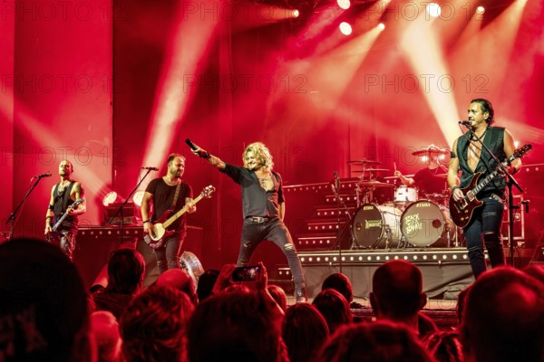 Ande Braun (guitarist), Steffen Haile (bassist), Hannes Braun (singer) and Jim Müller (guitarist) of the band Kissin' Dynamite live on Back with a Bang World Tour at Capitol Hannover on 09.11.2025