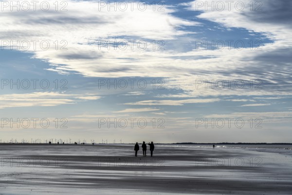 Walkers on the Wadden Sea near the East Frisian island of Spiekeroog, west of the North Sea island, at low tide, Lower Saxony, Germany