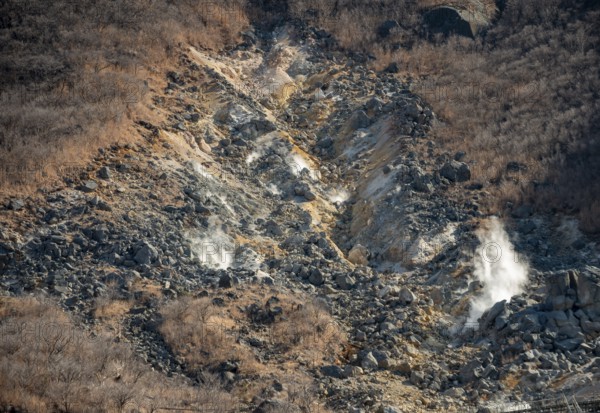 Steaming fumaroles in the Owakudani geothermal area at Komagatake volcano, Hakone, Japan