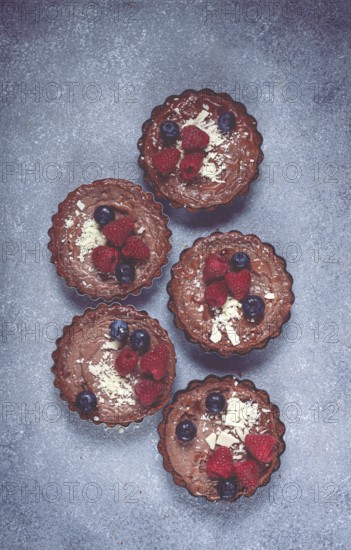 Chocolate tartlets, stuffed with cottage cheese and berries, breakfast, homemade, no people